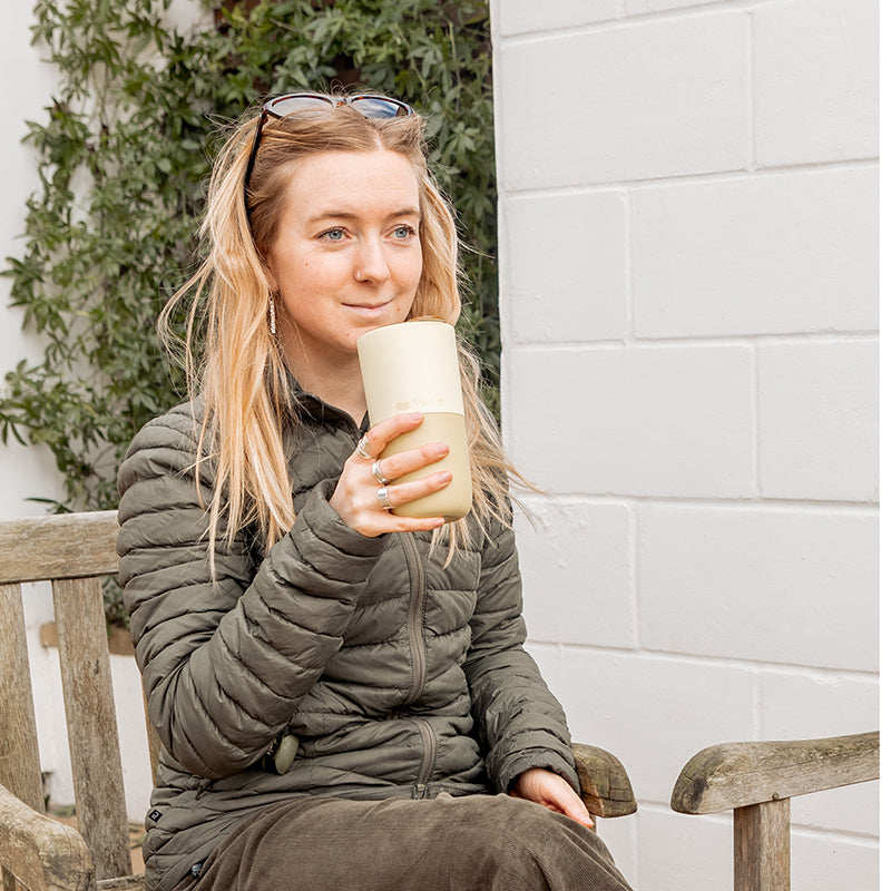 16oz-rise-tumbler-u3 16oz_rise_tumbler_wax_yellow_woman_seat_outside_square.jpg