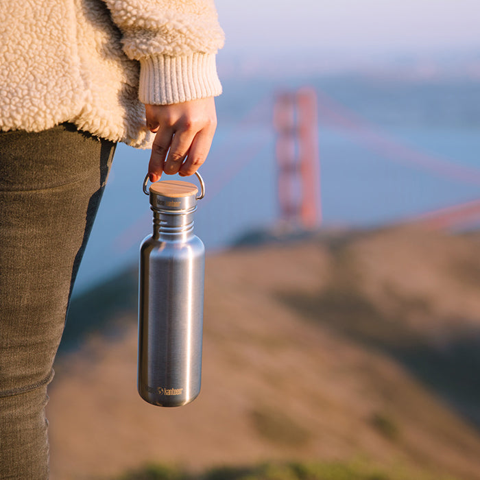 27oz-reflect-with-bamboo-cap-g1 K27SSLRF-BS-BAMBOO_reflect_bottle_bridge_lifestyle.jpg